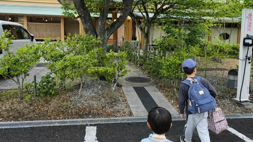 荷物をもって入口へ向かう子供たちの画像